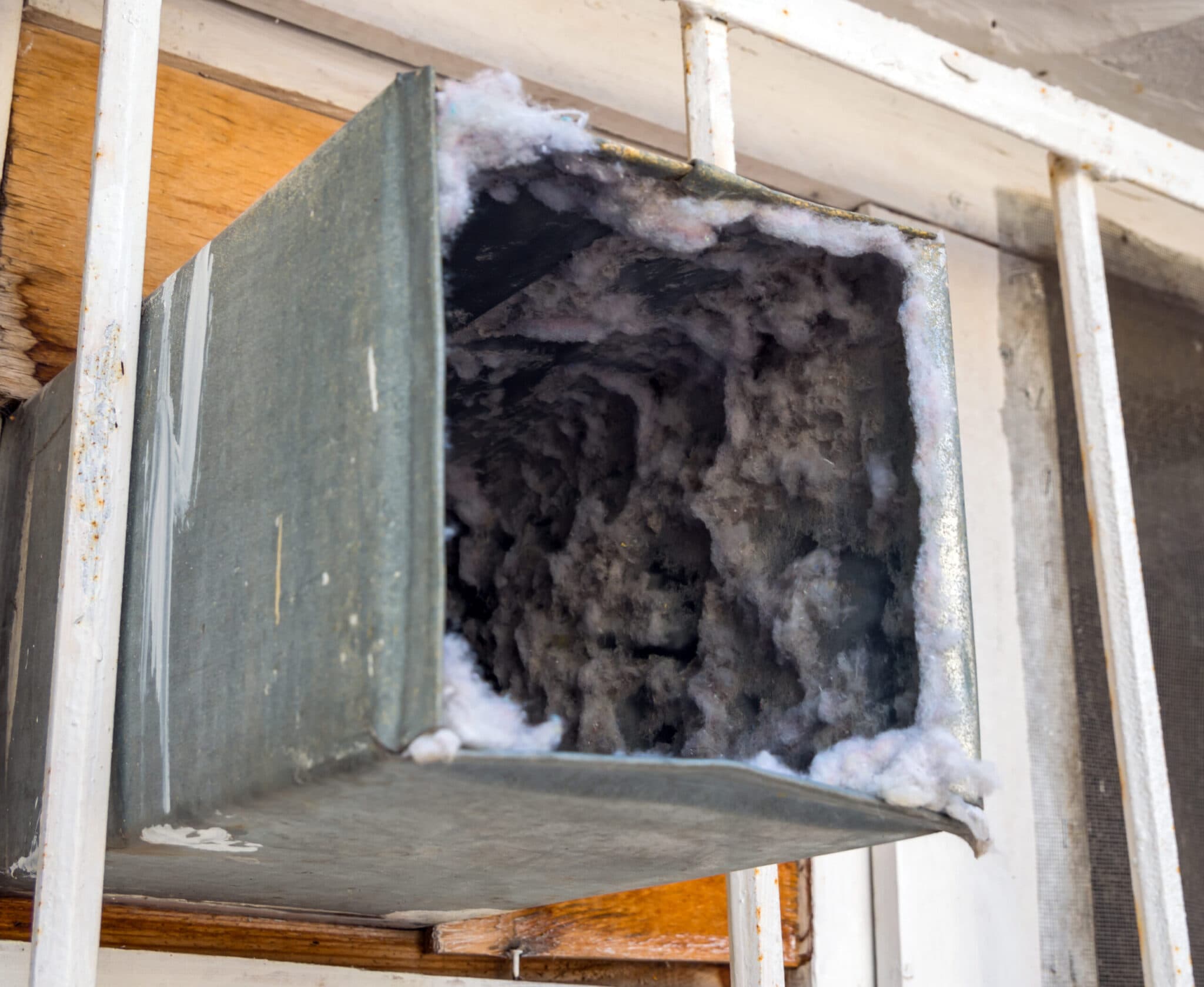 Attic Pros technician cleaning air ducts in a San Mateo home