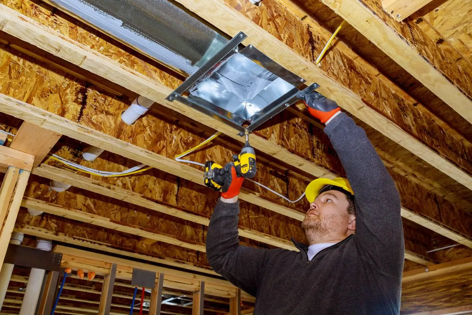 Attic Pros technician installing a replacement air conditioner