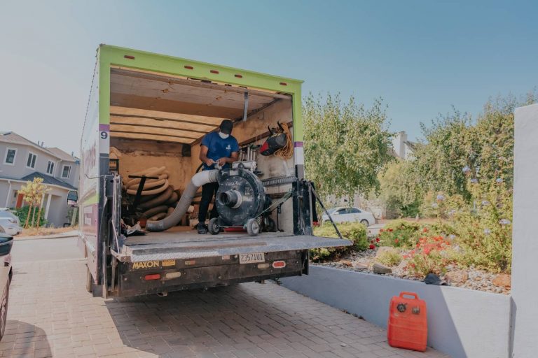 Attic Pros professional in blue shirt working in work truck