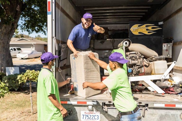 Attic Pros professionals taking materials off work truck