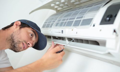 Man working on air conditioning unit